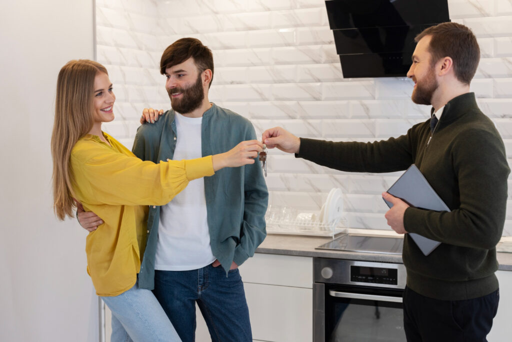 Three friends toasting with drinks in a cozy kitchen.